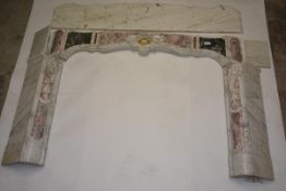 A Louis XV Provincial style variegated marble chimneypiece, probably 19th century, the serpentine