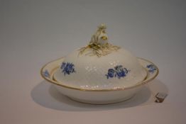 A 19th century tureen, possibly Davenport, circular, with domed moulded cover surmounted by a bud