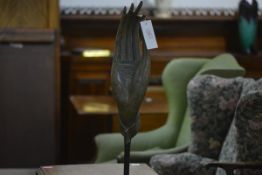 A bronze sculpture of a Buddhist hand, probably Thai, the elongated fingers extended, the palm