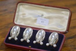 A cased set of four late Victorian egg-form silver pepperettes, London 1894 each on four ball