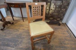 A set of six Robert "Mouseman" Thompson oak dining chairs, c. 1970, each with lattice back over a