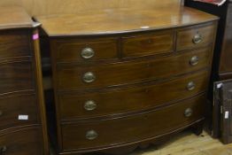 A George III style mahogany bowfronted chest of drawers, with three frieze drawers over three long