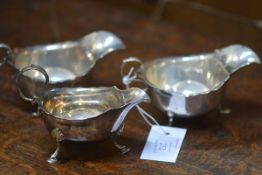 A pair of George V silver sauce boats, Chester 1913, each with scalloped rim, raised on paw feet;