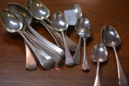 A set of twelve 18th and early 19th century silver dessert spoons, Old English pattern, various