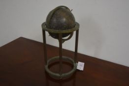 A bronze Islamic celestial globe, with calibrated meridian ring, on a stand with faceted uprights