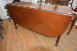 A George III mahogany gateleg dining table, early 19th century, with D-end leaves and raised on