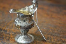 A George III silver cream jug, London 1779, of baluster form, on a pedestal foot, with later
