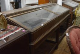 A large glazed oak display cabinet, with moulded rectangular top above a pair of glazed slant-