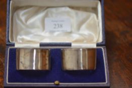 A cased pair of George VI silver napkin rings, London 1944 and 1945, not engraved.