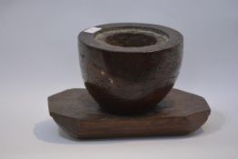 An 18th/early 19th century burr elm mortar, of tapering form, hollowed out and mounted on a (