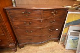 A George III mahogany chest of drawers, the serpentine top with canted corners above a conforming