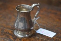 A Victorian silver christening tankard, London 1848, of baluster form, with capped scroll handle