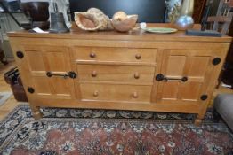 A Robert "Mouseman" Thompson oak 5' sideboard, c. 1970, the rectangular adzed top with ledge back