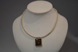 A Continental silver and amber (untested) necklace, the rectangular plaque suspended from a wire