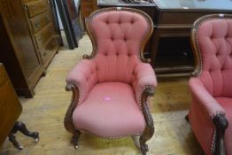 A Victorian walnut-framed buttoned spoon back armchair, with outscrolled arms, on cabriole legs