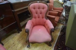 A Victorian walnut framed buttoned spoon back armchair, with outscrolled arms, on cabriole legs