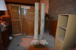 A pair of plaster fluted columns, with Ionic capitals, on square block plinths. 213cm