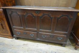 An 18th century oak mule chest, with moulded rectangular top over four fielded panels above two