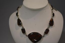 A Continental silver and amber (untested) plaque necklace, composed of graduated shaped plaques