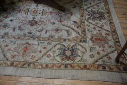 A modern Ziegler pattern carpet, the central panel with trailing stylised floral leaf and flowerhead