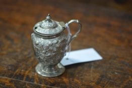 An American sterling silver mustard, late 19th century, of baluster form, heavily chased with