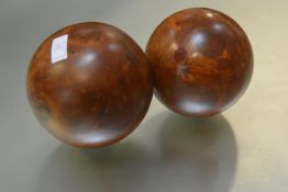 A pair of large decorative thuja burrwood balls. 19cm