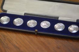 A cased set of six late Victorian silver buttons, Birmingham 1900, each chased with a Classical