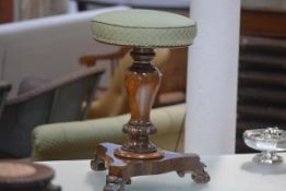 A William IV rosewood adjustable piano stool, with circular seat, on a baluster standard issuing