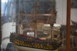 A large painted wooden model of an early 18th century three-masted man o' war, fully rigged, bearing