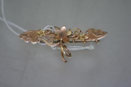 A Victorian 9ct gold brooch set to the centre with a small old-cut diamond within a flowerhead.