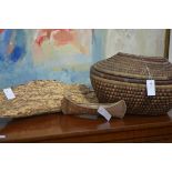 A group of tribal artefacts comprising two model canoes and a covered basket (3)