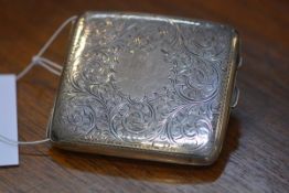 A George V silver cigarette case, Birmingham 1922, of rectangular form, engraved with foliate