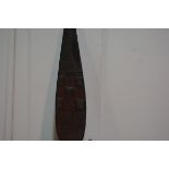 A West African carved wooden dance paddle, the leaf-shaped blade carved with lizards and geometric