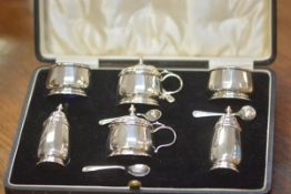 A George V cased silver condiment set, Birmingham 1931, comprising a pair of salts, pepperettes