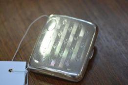 An Edwardian silver cigarette case, Chester 1908, shaped for the hand, engraved with bands of