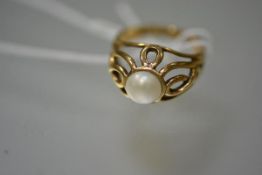 A cultured pearl ring set in 9ct gold, the pearl in a high openwork setting, mounted in yellow