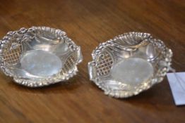 A pair of George V silver bon bon dishes, Birmingham 1910, oval, with trellis pierced sides and