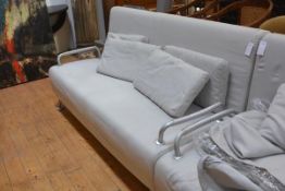 An Italian contemporary sofa bed by BBB Emmebonacina, in grey, with fold out seat and raised on