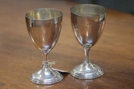A pair of George III Old Sheffield Plate goblets, c. 1800, each engraved with floral swags and a