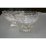 Two 19th century cut glass footed bowls of navette shape, the larger with scalloped rim, with