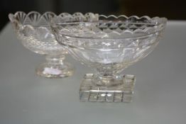 Two 19th century cut glass footed bowls of navette shape, the larger with scalloped rim, with