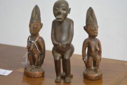 Two Nigerian carved wooden standing female figures, each with tall headdress, both decorated with