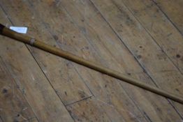 An early 20th century fruitwood walking cane inset with a torch, the bakelite handle unscrewing to