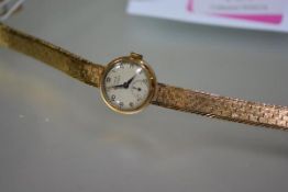 A vintage lady's Girard Perregaux 9ct gold wristwatch on a 9ct gold bracelet strap, the circular