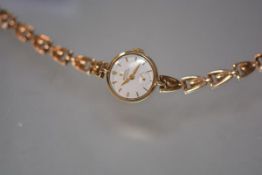 A vintage Rolex Precision lady's 9ct gold wristwatch on a 9ct gold bracelet strap, the circular