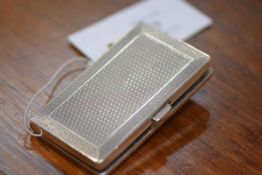 A George V silver cigarette case, Birmingham 1929, with engine-turned decoration and bands of