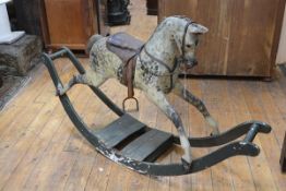 An English painted wooden rocking horse, c. 1900, possibly G & J Lines or Ayres, with glass eyes,