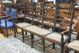 An elm and oak chair-back settle, of Lancashire type, with four ladder backs above drop-in rush