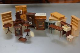 A quantity of 20th century doll's house furniture including: Georgian style corner cupboards,