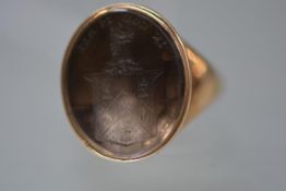 A 19th century gentleman's gold ring set with an oval hardstone intaglio engraved with a crest and